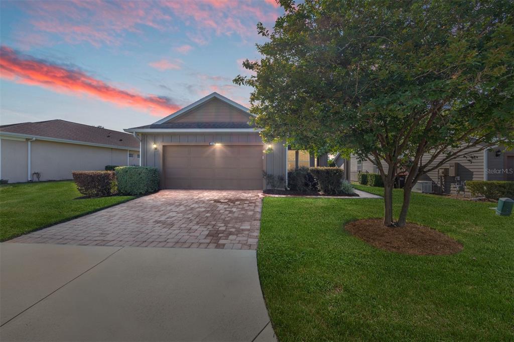 4970 Northwest 35th Ln Road Ocala, FL 34482 - Photo 3 of 41 a front view of a house with a garden and trees