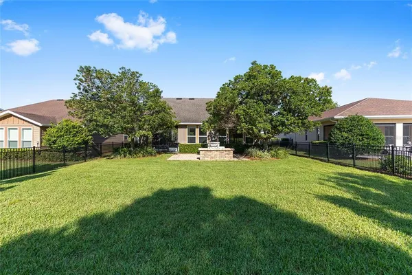 a view of a house with a backyard