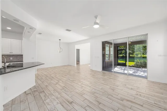 a view of a kitchen with a sink and a window