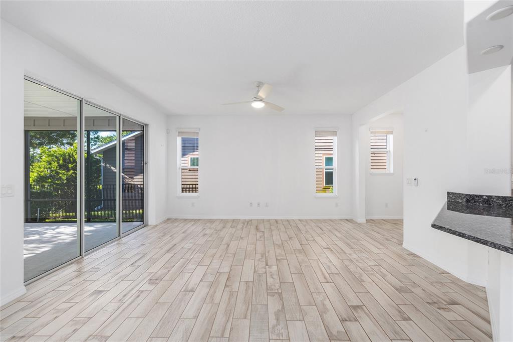 4970 Northwest 35th Ln Road Ocala, FL 34482 - Photo 10 of 41 a view of empty room with wooden floor and fan