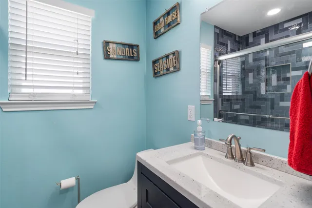 a bedroom with a bed a chandelier and a large window