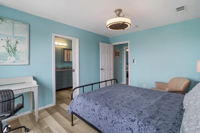 a bathroom with a granite countertop sink toilet a mirror and shower