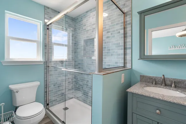 a bedroom with two beds and chandelier