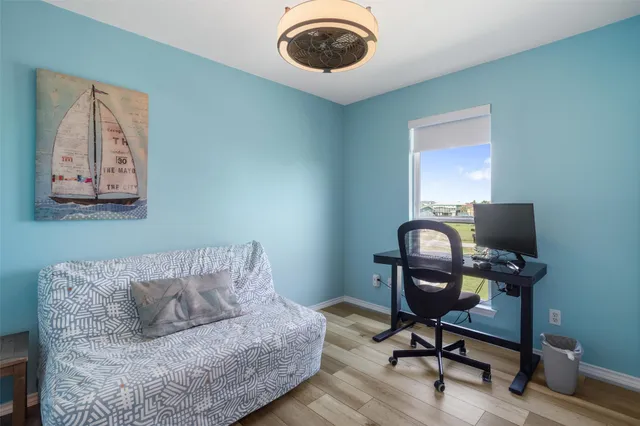 a view of a swimming pool with lawn chairs and a big yard