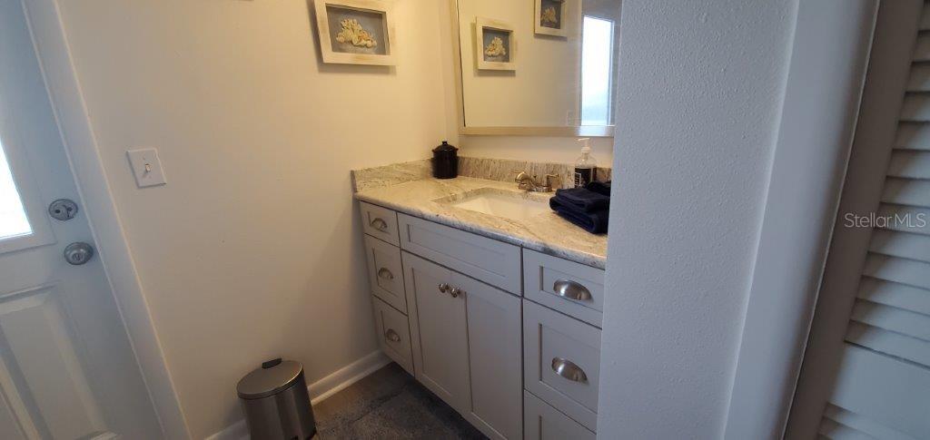 2122 Cassino Court Punta Gorda, FL 33950 - Photo 16 of 25 a bathroom with a granite countertop sink and a mirror