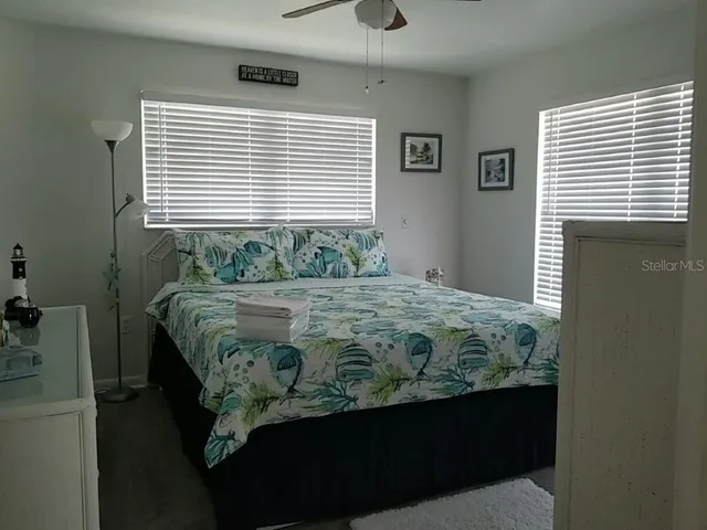a bedroom with a bed dresser and a window