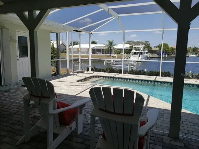 a view of balcony with a dining table and chairs