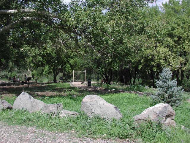 4195 East Beaver Vista Road, Unit 17 Rimrock, AZ 86335 - Photo 5 of 6 a view of a table and chairs in backyard of house