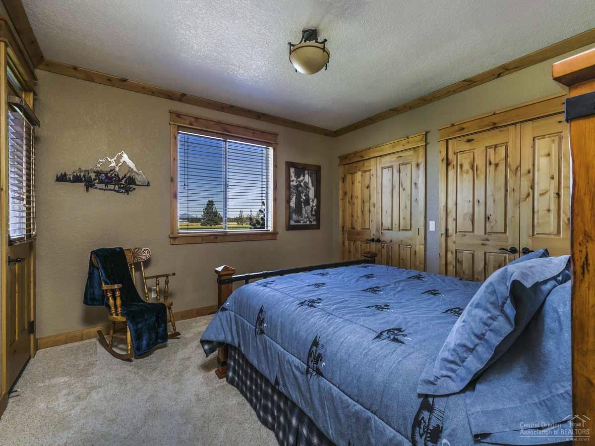 20200 Marsh Road Bend, OR 97703 - Photo 18 of 25 a bedroom with a bed and a table