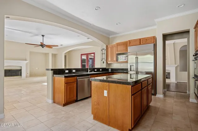 a kitchen with stainless steel appliances granite countertop a stove and a refrigerator