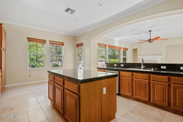 a kitchen with stainless steel appliances granite countertop a sink and a stove