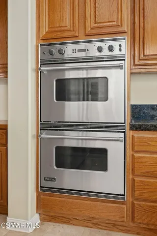 a stove top oven sitting inside of a kitchen