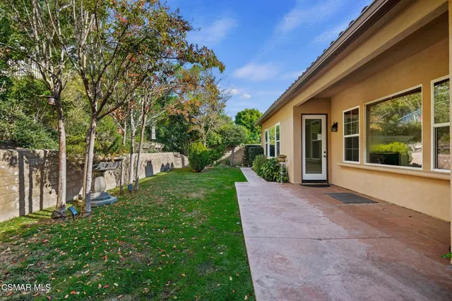 a front view of a house with a garden and yard