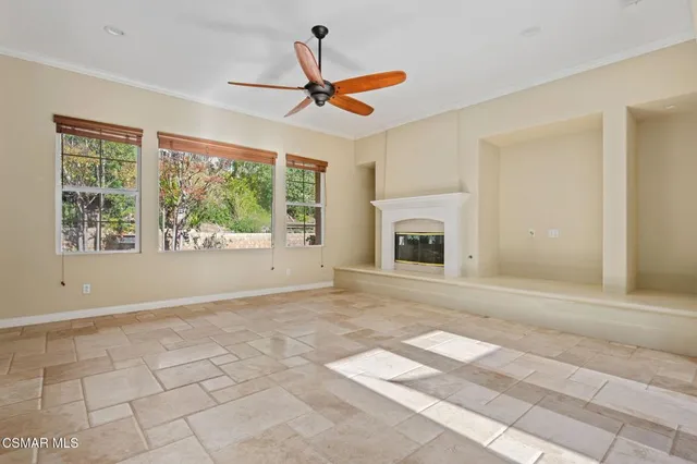 a view of a livingroom with a ceiling fan and window