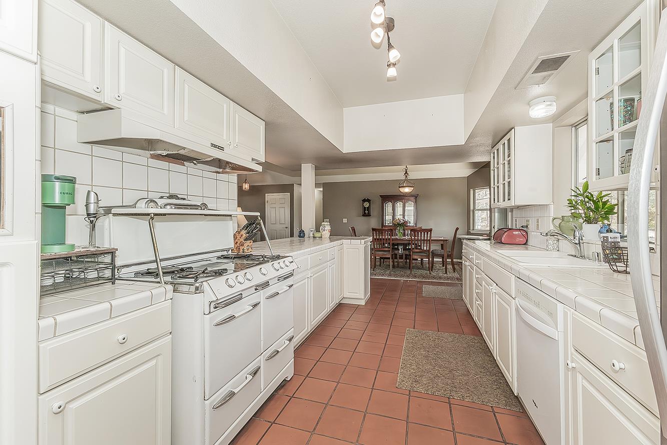 14815 Garlock Lane Prather, CA 93651 - Photo 18 of 80 a large kitchen with stainless steel appliances lots of counter space and a sink