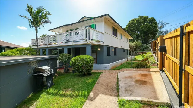 a view of a house with backyard and sitting area