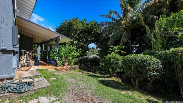a view of a backyard with plants and a patio