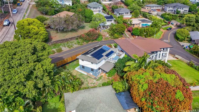 an aerial view of a house with garden space and street view