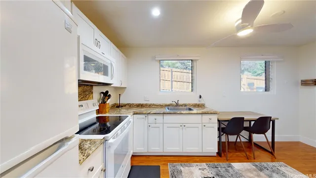 a kitchen with a sink cabinets and window