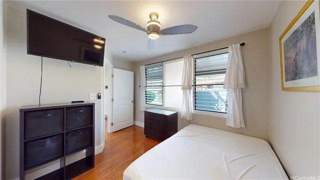 a bedroom with a bed dresser and a window