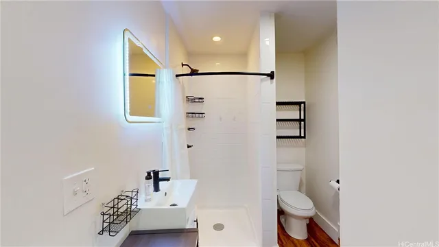 a bathroom with a toilet sink and shower