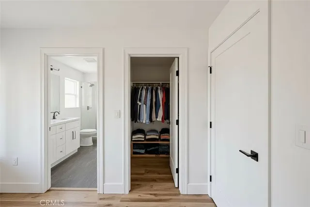 a hallway with white doors and wooden floor