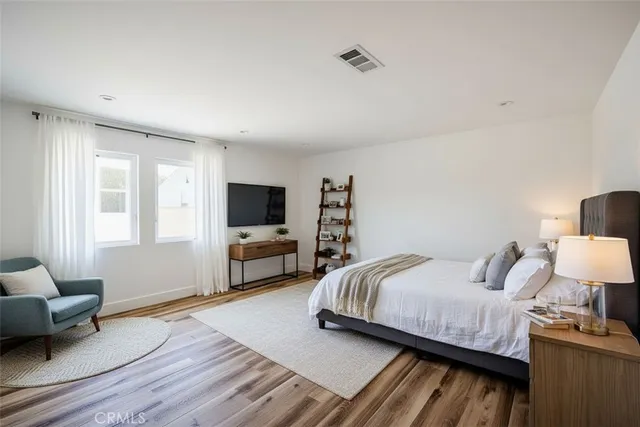 a bedroom with a bed and a couch