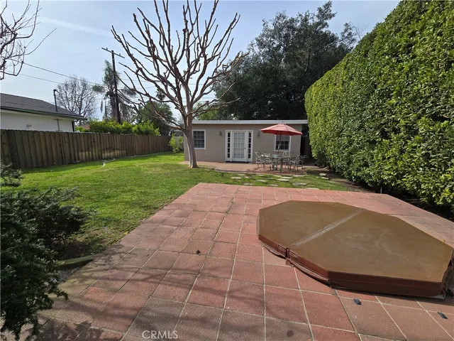 a view of backyard of house with green space