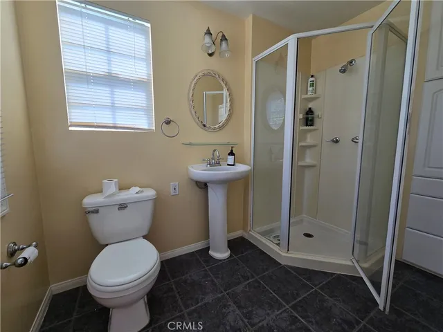 a bathroom with a toilet sink and a shower