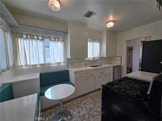 a kitchen with a sink stove and refrigerator