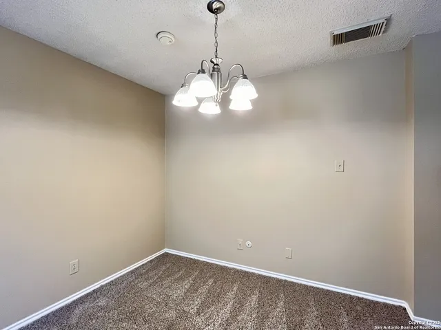 a view of a small space with wooden floor and a window