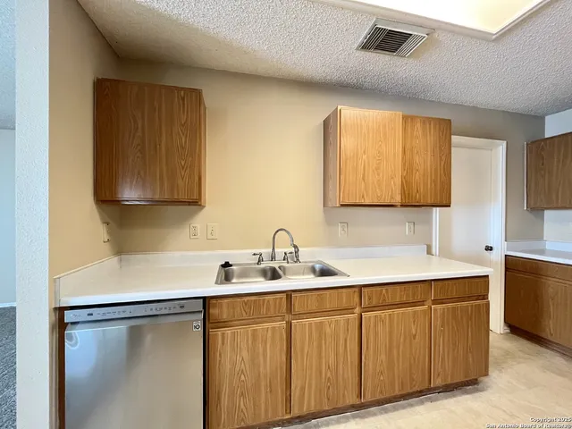 a kitchen with a sink cabinets and window