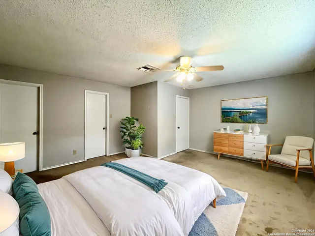 a bedroom with a bed couch and window