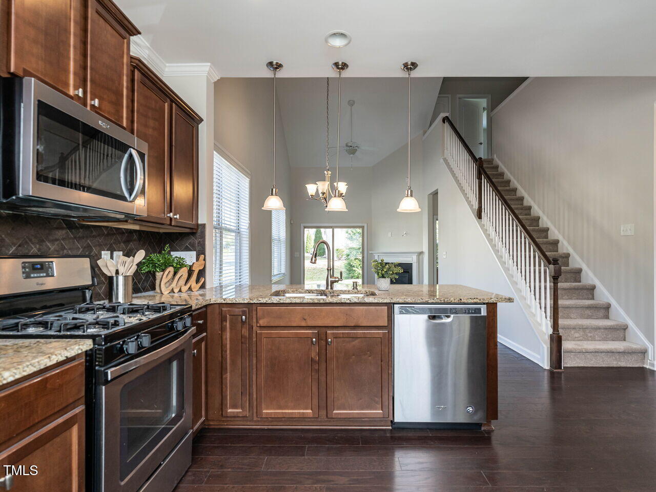 11 St Elias Drive Durham, NC 27705 - Photo 11 of 34 a kitchen with stainless steel appliances granite countertop a stove and a microwave