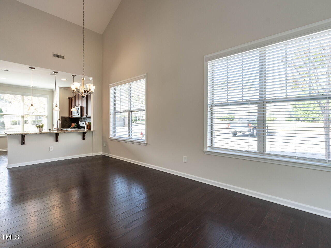11 St Elias Drive Durham, NC 27705 - Photo 20 of 34 a view of a living room and kitchen with furniture wooden floor