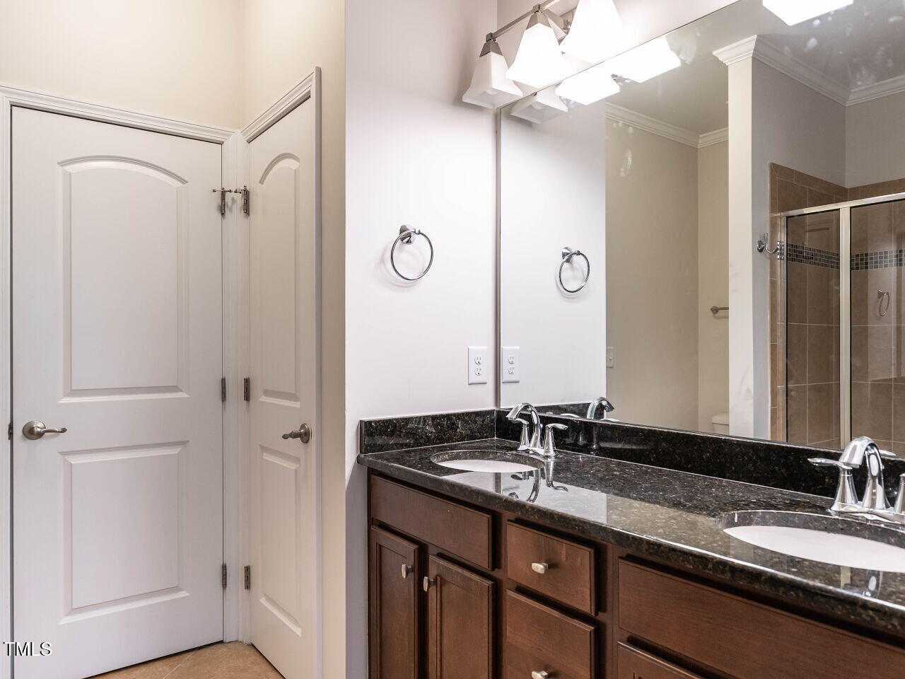 11 St Elias Drive Durham, NC 27705 - Photo 23 of 34 a bathroom with a granite countertop sink and a mirror