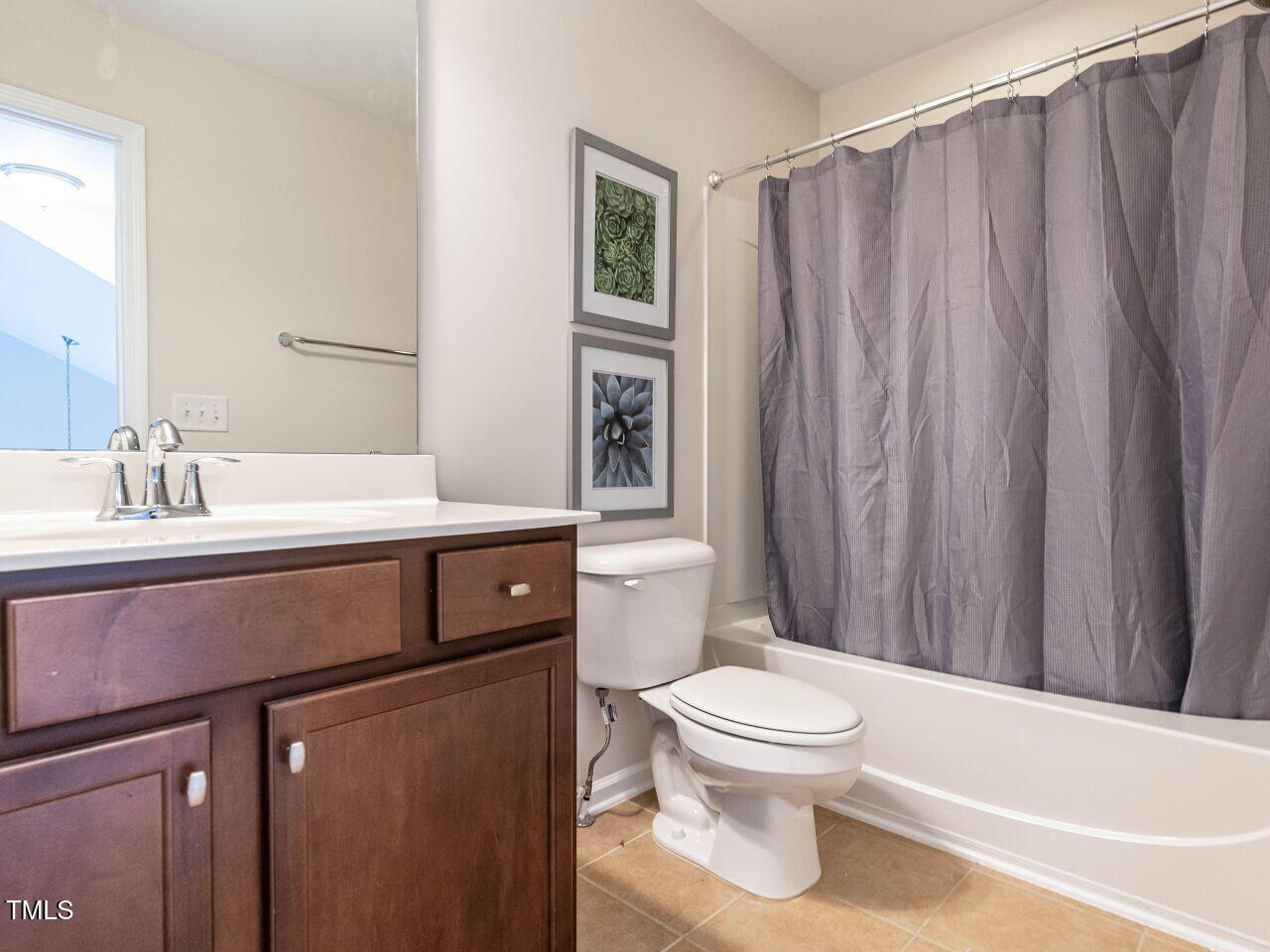 11 St Elias Drive Durham, NC 27705 - Photo 29 of 34 a bathroom with a sink a toilet and shower
