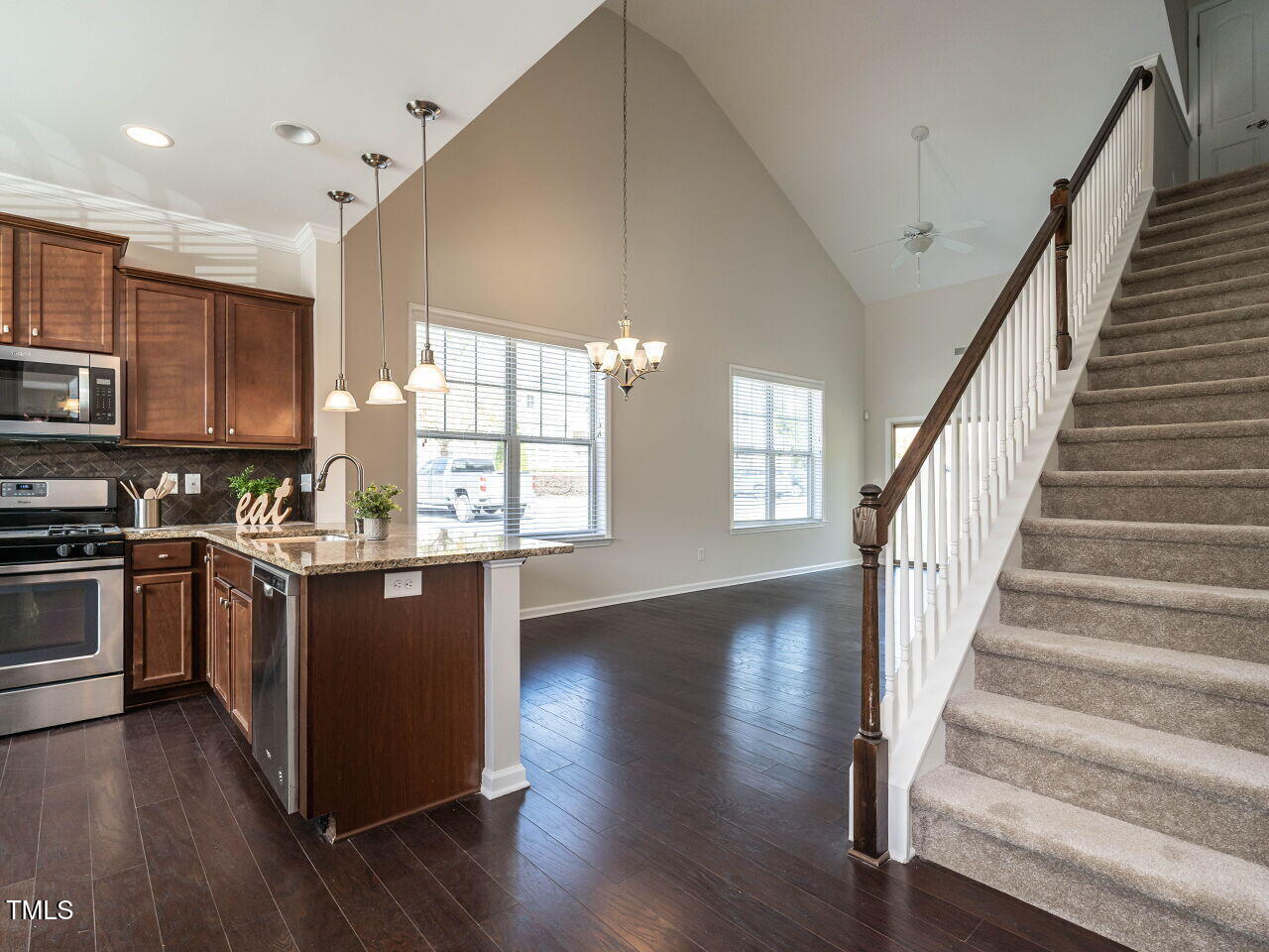 11 St Elias Drive Durham, NC 27705 - Photo 6 of 34 a kitchen with stainless steel appliances granite countertop a refrigerator a stove top oven and a sink with cabinets