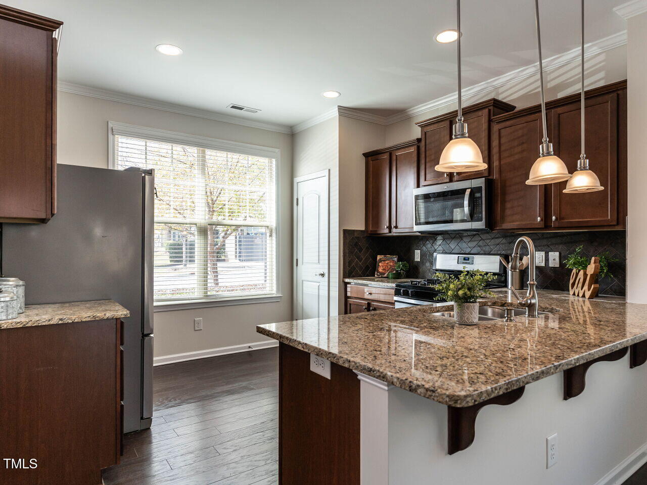 11 St Elias Drive Durham, NC 27705 - Photo 7 of 34 a kitchen with granite countertop a sink a counter space appliances and cabinets