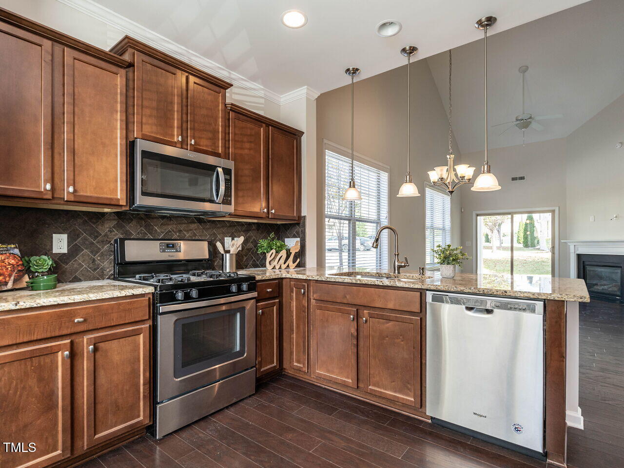 11 St Elias Drive Durham, NC 27705 - Photo 10 of 34 a kitchen with stainless steel appliances a stove a sink and cabinets