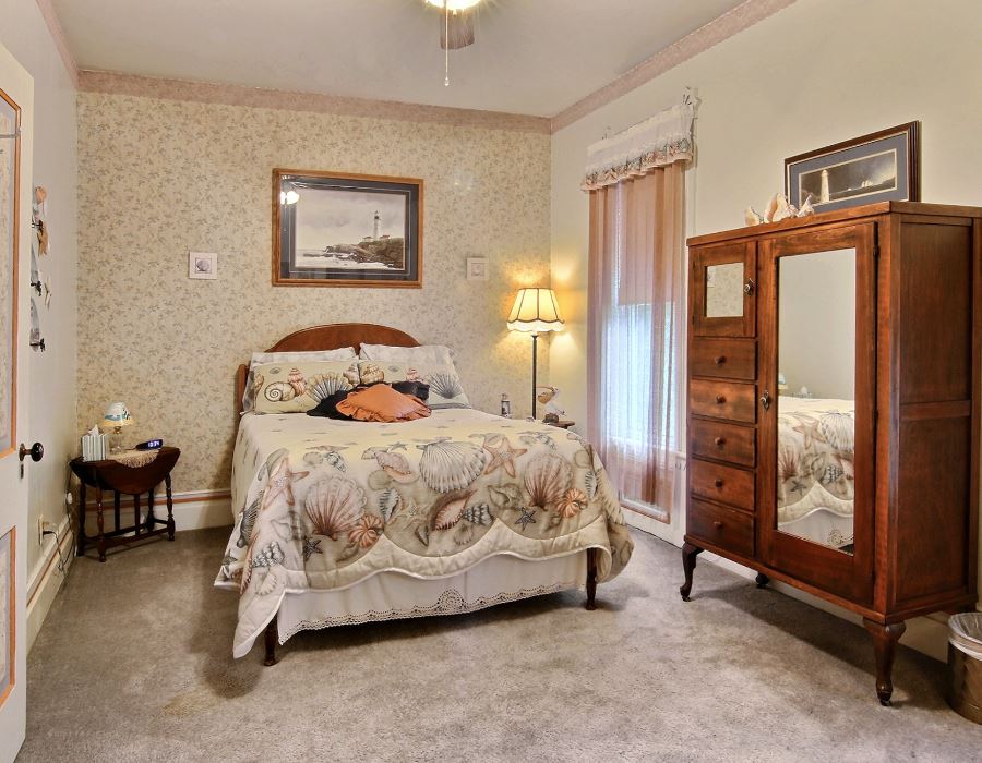 8430 West State Road Rockford, IL 61102 - Photo 11 of 25 a bedroom with a bed and large mirror next to a window