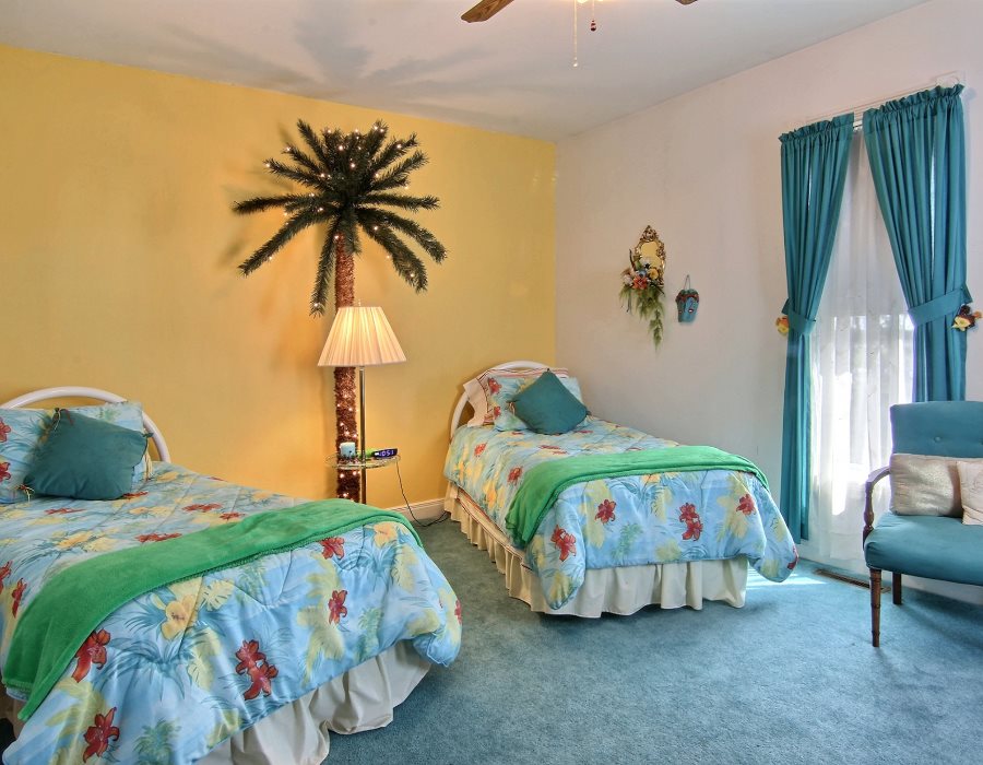 8430 West State Road Rockford, IL 61102 - Photo 14 of 25 a bedroom with two beds and a chandelier