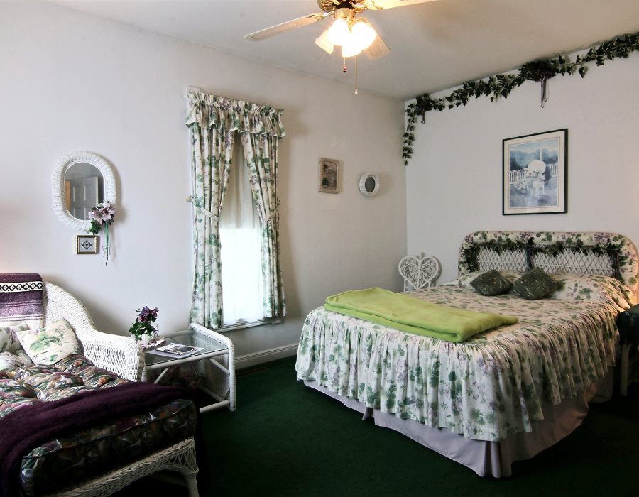 8430 West State Road Rockford, IL 61102 - Photo 15 of 25 a bedroom with a bed and a chandelier