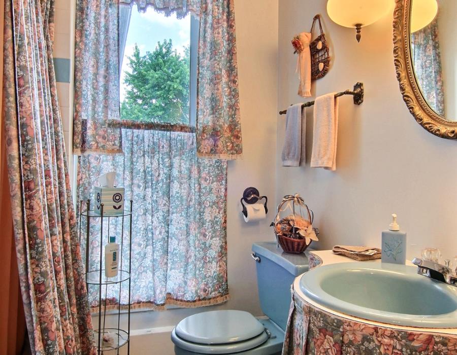 8430 West State Road Rockford, IL 61102 - Photo 16 of 25 a bathroom with a sink a toilet and shower curtain