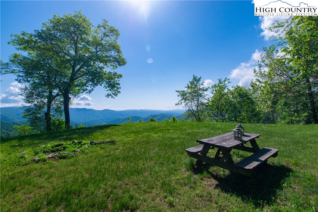 Storie Road Deep Gap, NC 28618 - Photo 20 of 27 a wooden bench sitting in the grass near a tree