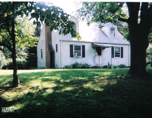 a view of a house with yard and a tree