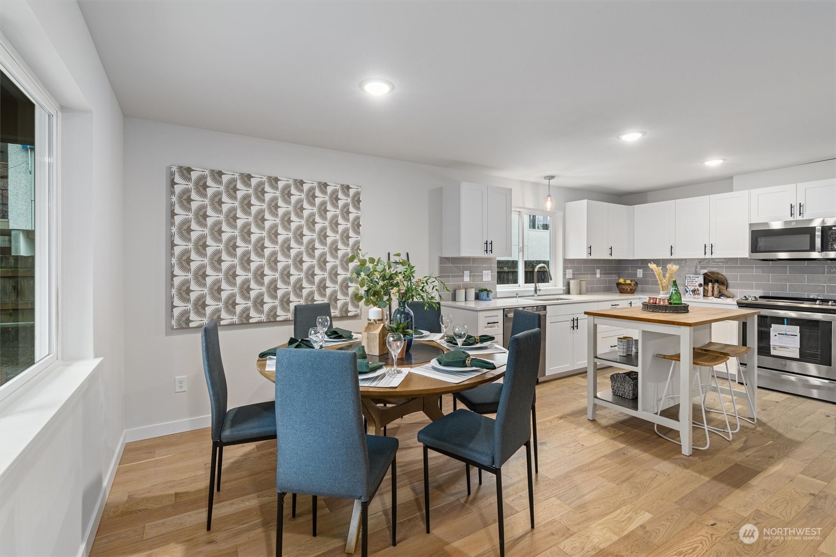2412 Northwest 64th Street Seattle, WA 98107 - Photo 11 of 31 a view of a dining room with furniture and wooden floor