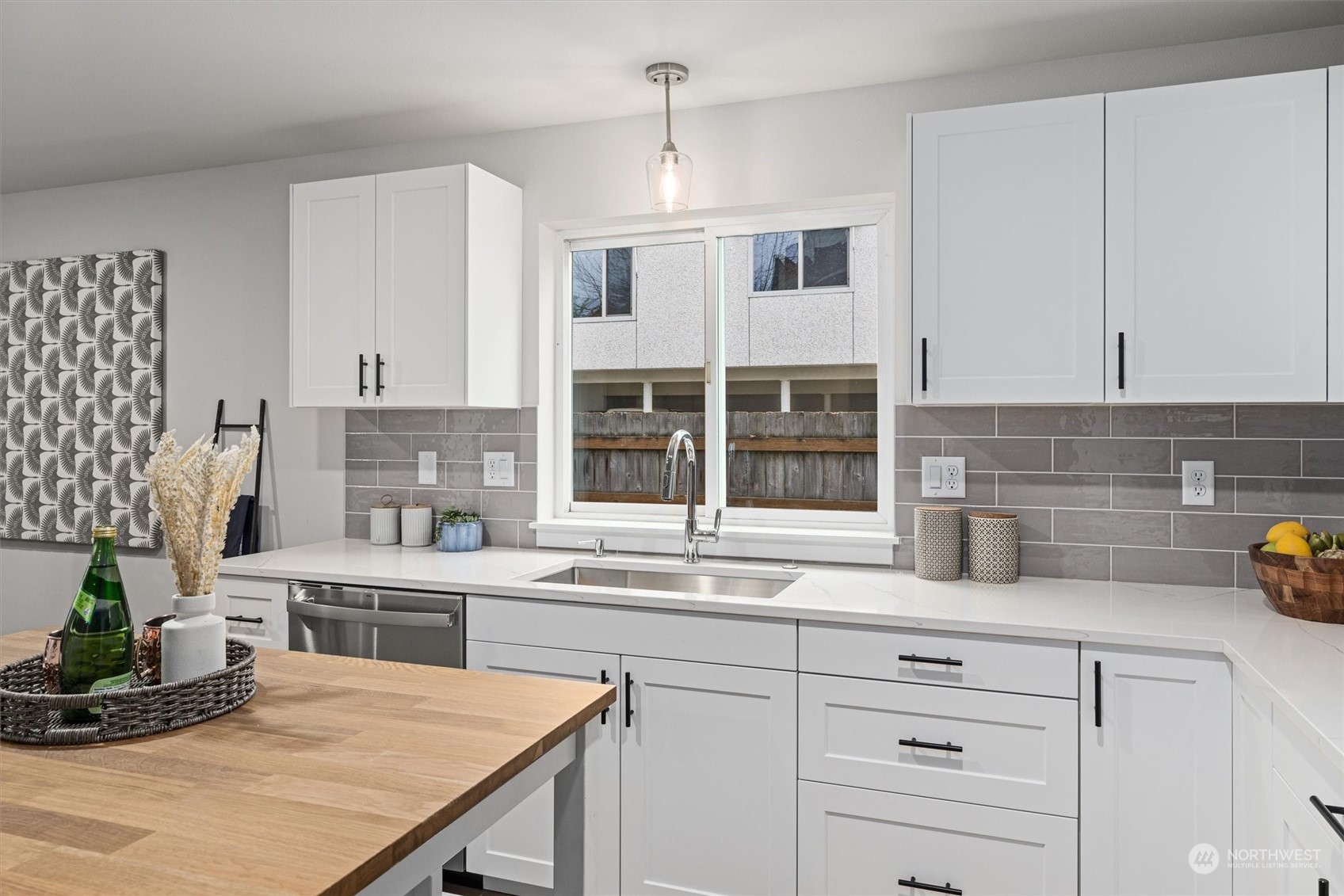 2412 Northwest 64th Street Seattle, WA 98107 - Photo 15 of 31 a kitchen with cabinets a center island and appliances