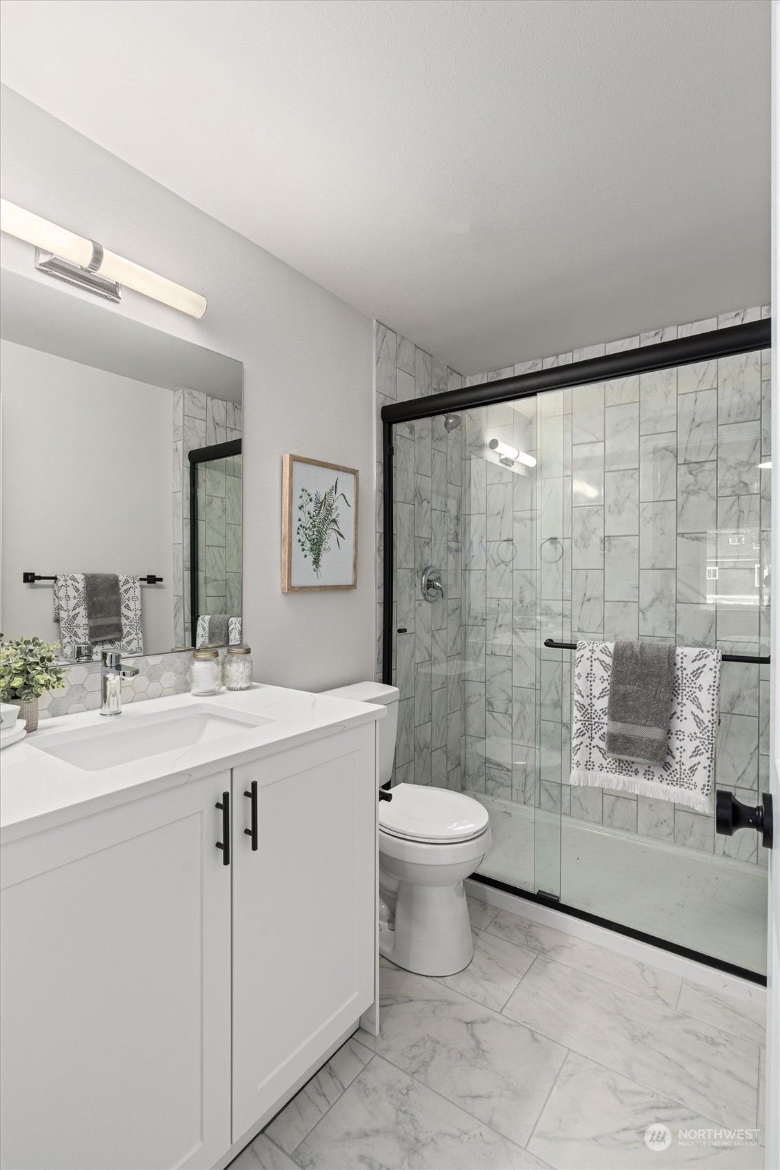2412 Northwest 64th Street Seattle, WA 98107 - Photo 22 of 31 a bathroom with a double vanity sink toilet and shower