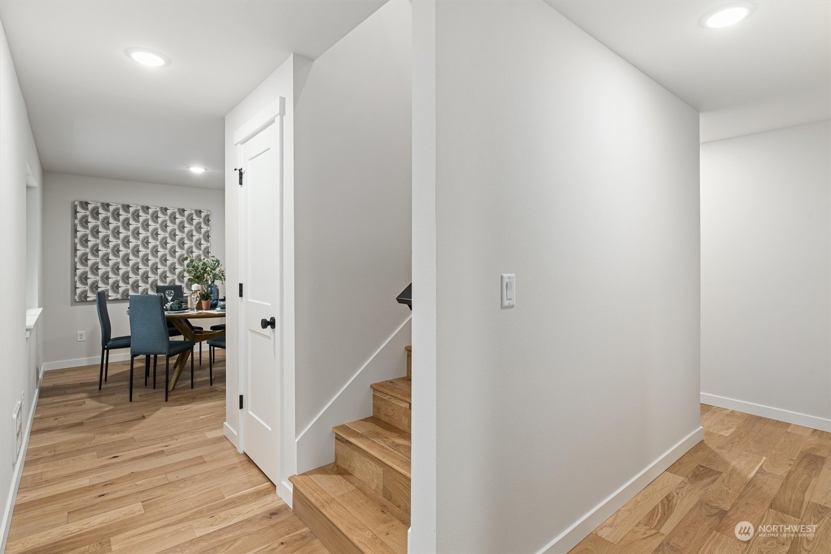 2412 Northwest 64th Street Seattle, WA 98107 - Photo 5 of 31 a view of a hallway with wooden floor and a dining room